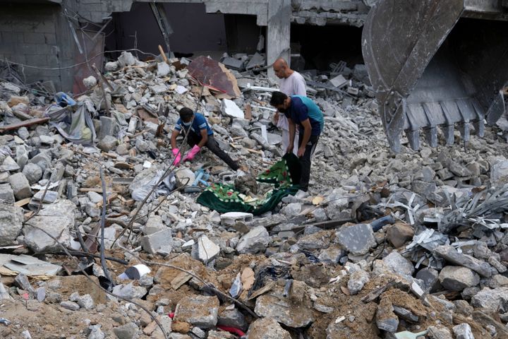 Palestinians recover the bodies of the al Meghari family killed in the Israeli bombardment of the Gaza Strip in Bureij refugee camp, Gaza Strip, Tuesday, Nov. 14, 2023. (AP Photo/Adel Hana)