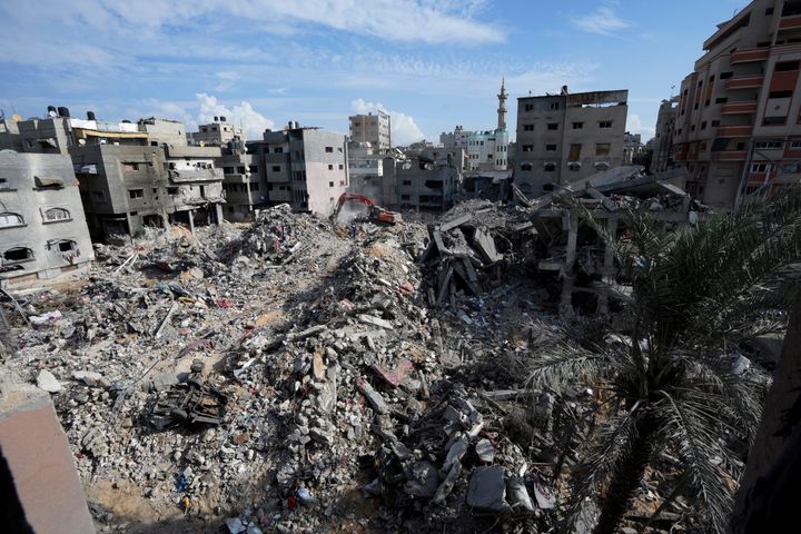 Palestinians search for the bodies of the al Meghari family killed in the Israeli bombardment of the Gaza Strip in Bureij refugee camp, Gaza Strip, Tuesday, Nov. 14, 2023. (AP Photo/Adel Hana)