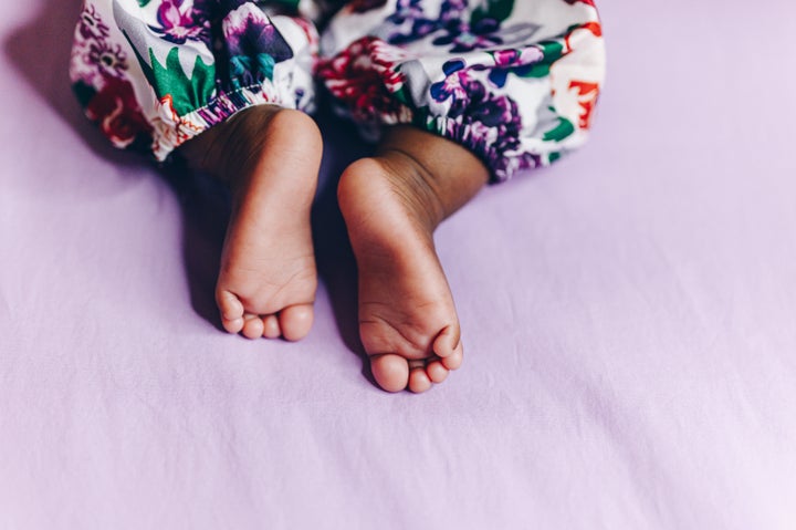 Cute little feet of newborn baby