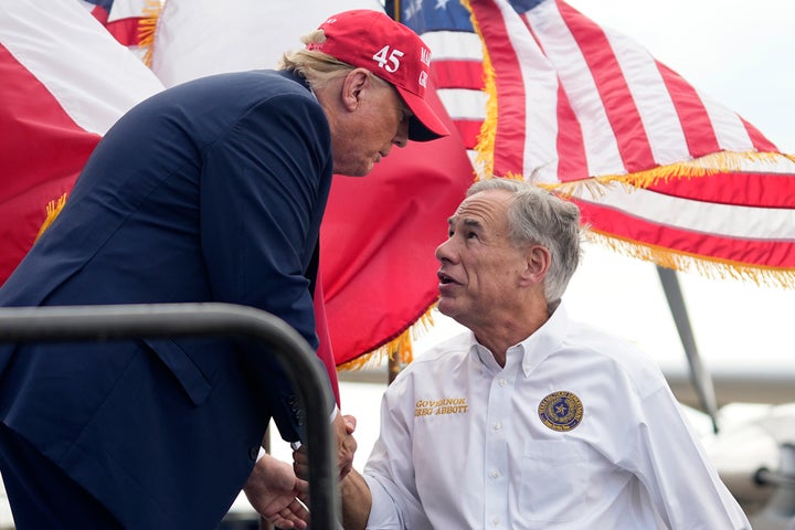 Republican presidential candidate and former President Donald Trump, left, shakes hands with Texas Gov. Greg Abbott, right, after he received Abbott's endorsement at the South Texas International Airport Sunday, Nov. 19, 2023, in Edinburg, Texas. (AP Photo/Eric Gay)