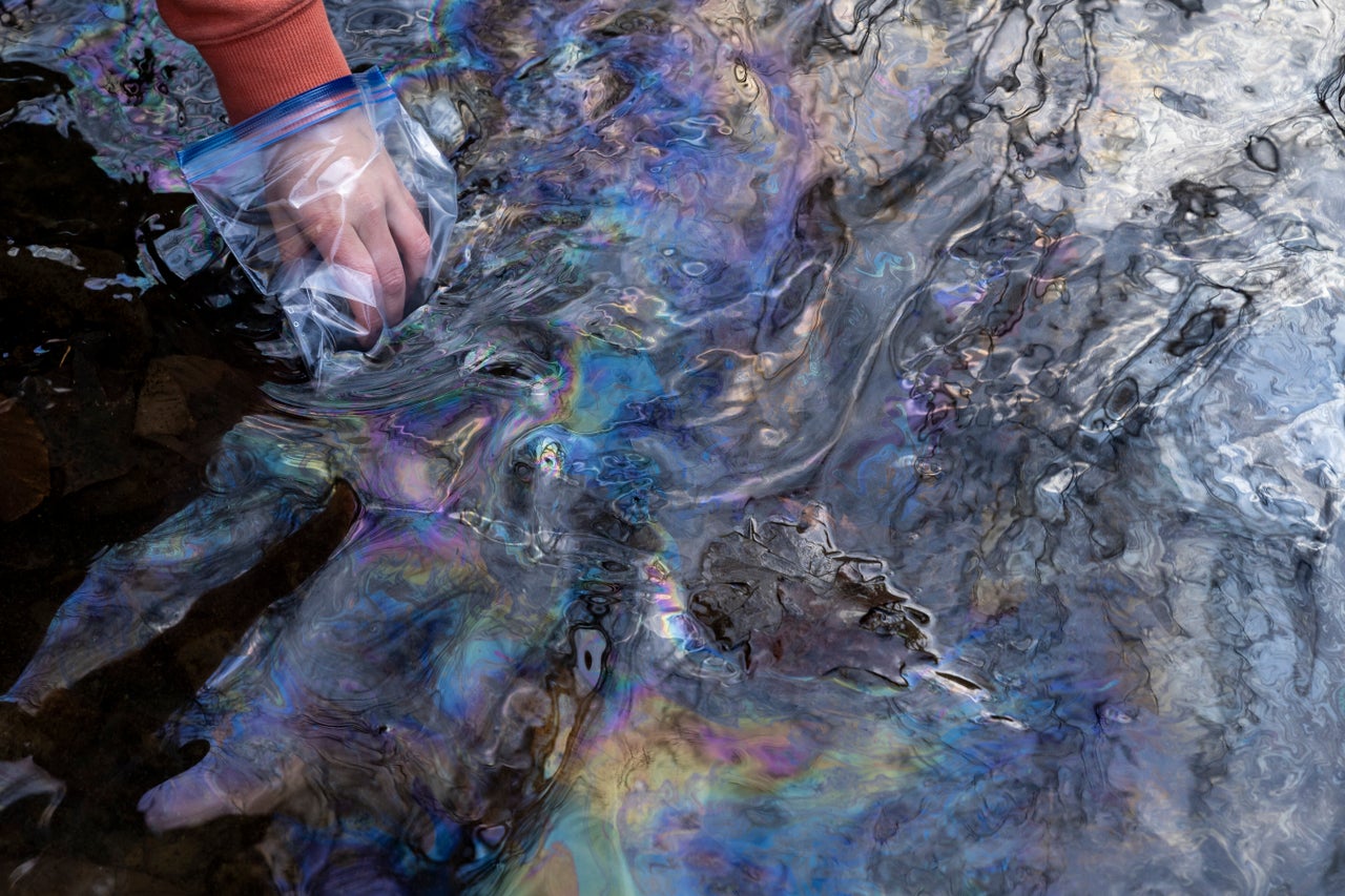 Disaster responders collect water samples from a polluted creek on Feb. 25 in East Palestine, Ohio.