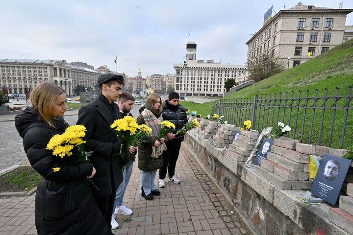 People gather by the memorial of Maidan activists in Kyiv on November 21, 2023. 