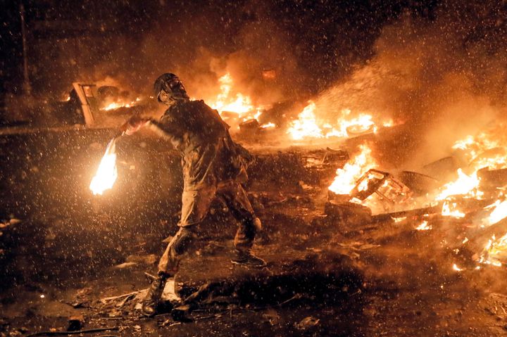January 22, 2014 file photo a protester throws a Molotov cocktail during clashes with police in central Kyiv, Ukraine.