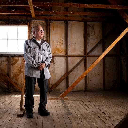 Paul Tomita poses for a portrait in a historic barracks at Minidoka National Historic Site, July 8, 2023, in Jerome, Idaho.