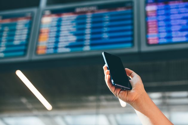 Woman checks airline schedule at airport.