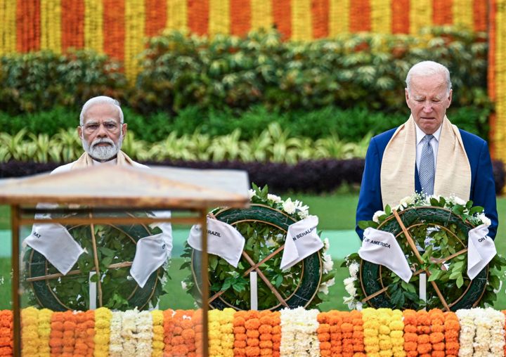 India's Prime Minister Narendra Modi (L) and US President Joe Biden pay respect at the Mahatma Gandhi memorial at Raj Ghat on the sidelines of the G20 summit in New Delhi on September 10, 2023. (Photo by Kenny HOLSTON / POOL / AFP) (Photo by KENNY HOLSTON/POOL/AFP via Getty Images)