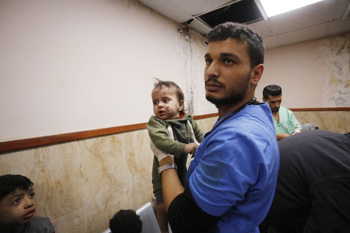 DEIR AL BALAH, GAZA - NOVEMBER 22: A man carries an injured Palestinian baby to Al Aqsa hospital after Israeli airstrike in Deir al-Balah, Gaza on November 22, 2023. (Photo by Ashraf Amra/Anadolu via Getty Images)