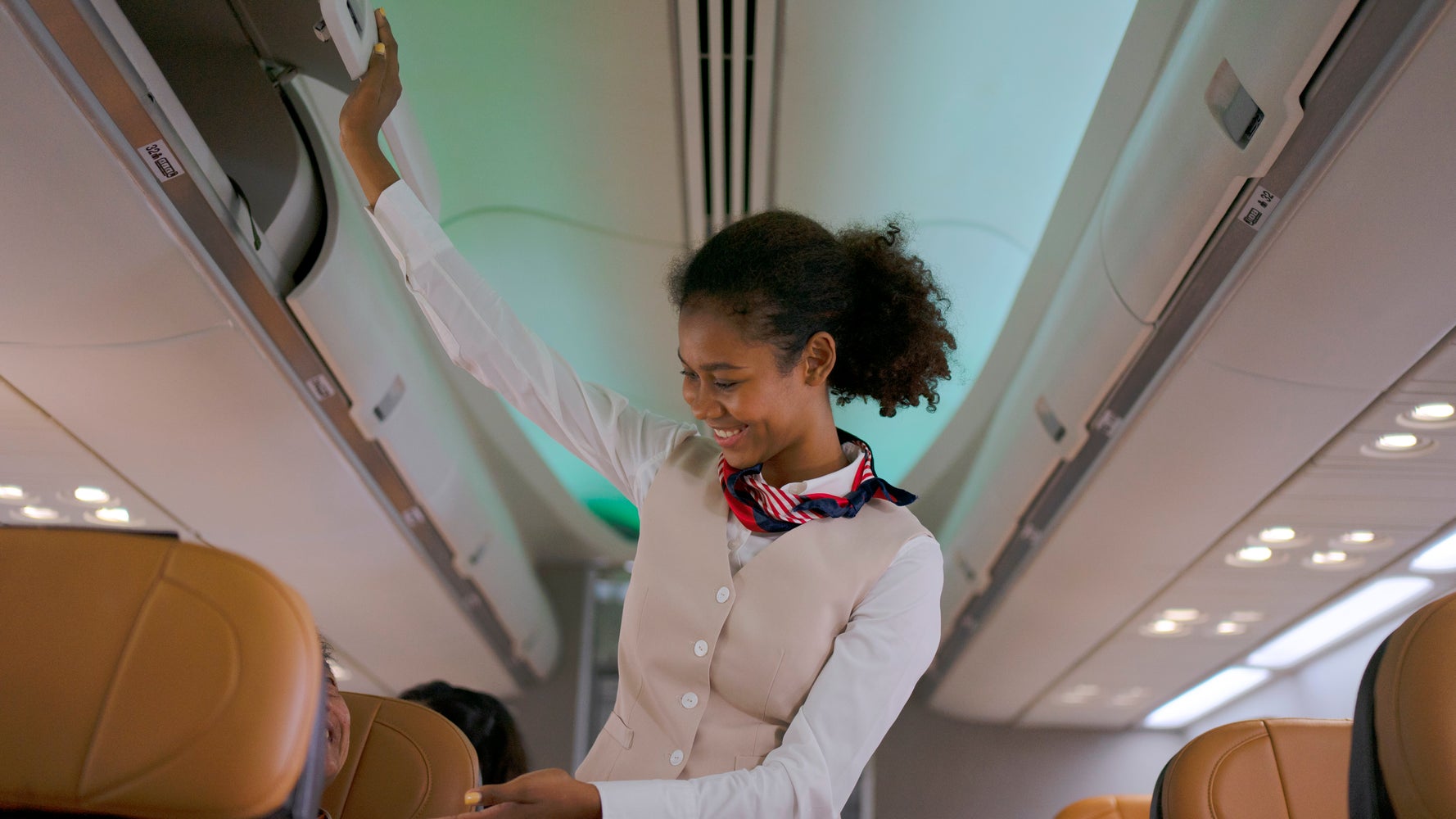 Why do flight attendants sit on their hands?