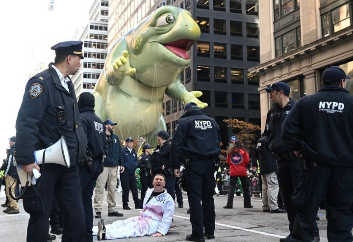 New York City police officers take two pro-Palestinian protesters into custody during the Thanksgiving Day parade.