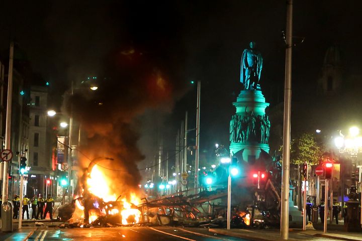 A vehicle in flames in O'Connell Street after violence broke out following five people were wounded in a stabbing attack, including three children and a woman, in Ireland's capital Dublin on November 23, 2023.