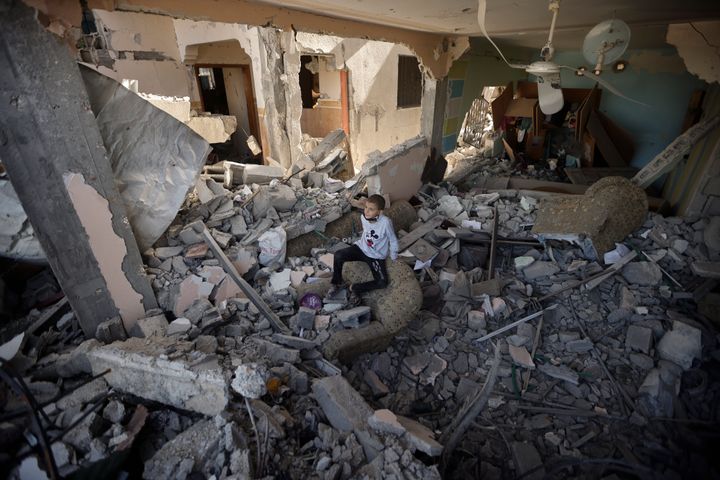 Palestinians inspect their destroyed houses in the town of Kazaa, eastern Khan Younis, southern Gaza Strip, on Nov. 24, 2023, as the four-day cease-fire in the Israel-Hamas war begins as part of an agreement that Qatar helped broker.