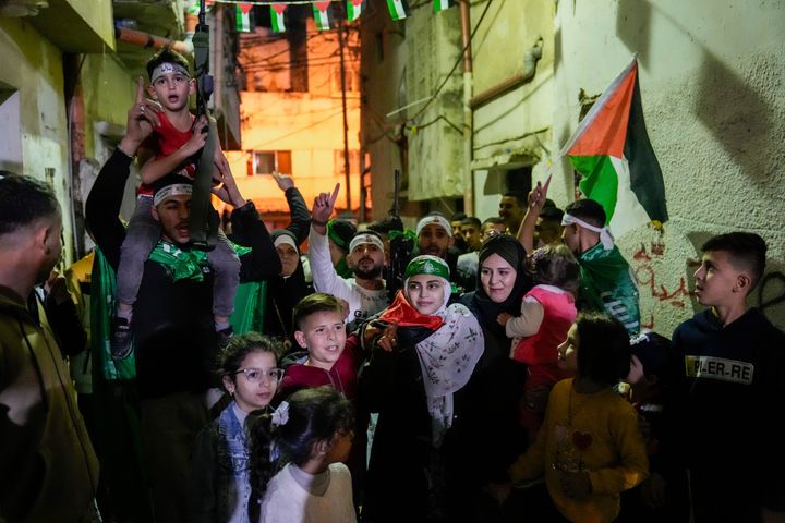 Aseel al-Titi, wearing a Hamas headband, a former Palestinian prisoner who was released by the Israeli authorities, is greeted by friends and family members in Balata, a Palestinian refugee camp in Nablus, West Bank, Friday, Nov. 24, 2023. The release came on the first day of a four-day cease-fire deal between Israel and Hamas during which the Gaza militants have pledged to release 50 hostages in exchange for 150 Palestinians imprisoned by Israel. (AP Photo/Majdi Mohammed)