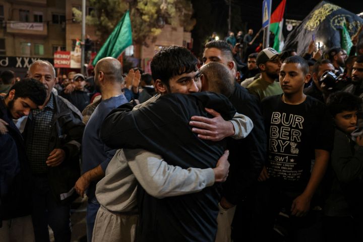 A Palestinian prisoner (L) is welcomed by a relative after being released from Israeli jails in exchange for hostages released by Hamas from the Gaza Strip, as newly freed Palestinian detainees arrived in Ramallah in the occupied West Bank early on November 26, 2023. Hamas on November 25, released a second group of Israeli and foreign civilians it had been holding hostage in the Gaza Strip in exchange for Palestinian prisoners, after an hours-long unexpected delay set nerves on edge. Israeli authorities said 13 Israelis and four Thai citizens had returned to Israel. (Photo by AHMAD GHARABLI / AFP) (Photo by AHMAD GHARABLI/AFP via Getty Images)