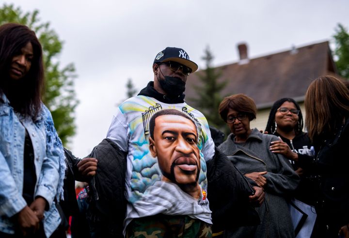 MINNEAPOLIS, MN - MAY 25: Terrence Floyd (C) removes his jacket to show a shirt bearing the face of his brother, George Floyd, during a vigil on May 25, 2022 in Minneapolis, Minnesota. (Photo by Stephen Maturen/Getty Images)