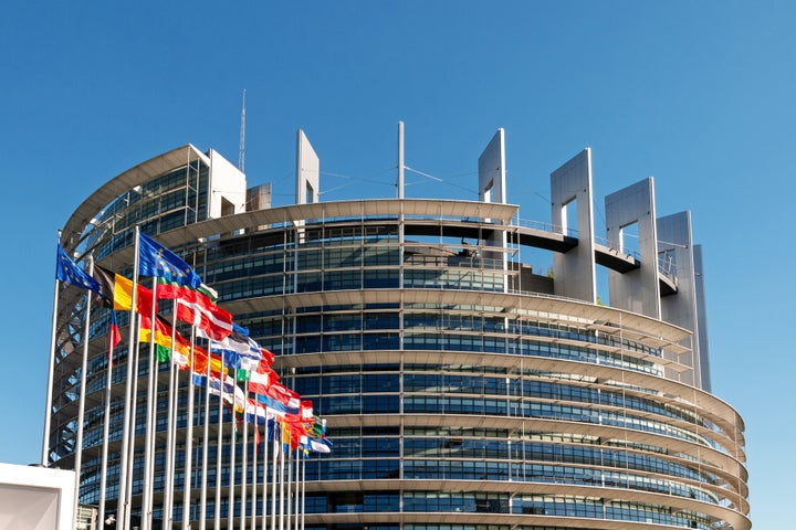 The European Parliament building in Strasbourg, France with flags waving calmly celebrating peace of the Europe. July 12, 2020.