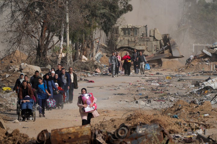 Palestinians flee south on the third day of a cease-fire between Israel and Hamas at Salah al-Din road in central Gaza Strip on Nov. 26, 2023.