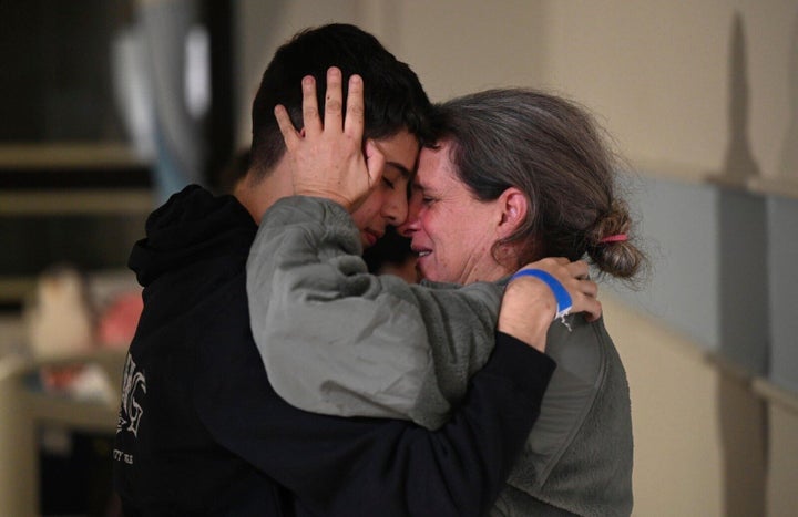 This handout photo provided by Haim Zach/GPO shows Sharon Hertzman, right, hugging a relative as they reunite at Sheba Medical Center in Ramat Gan, Israel, on Nov. 25, 2023. Sharon Hertzman and her daughter Noam, 12 years old, not pictured, were released by Hamas after being held as hostages in Gaza for 50 days. 