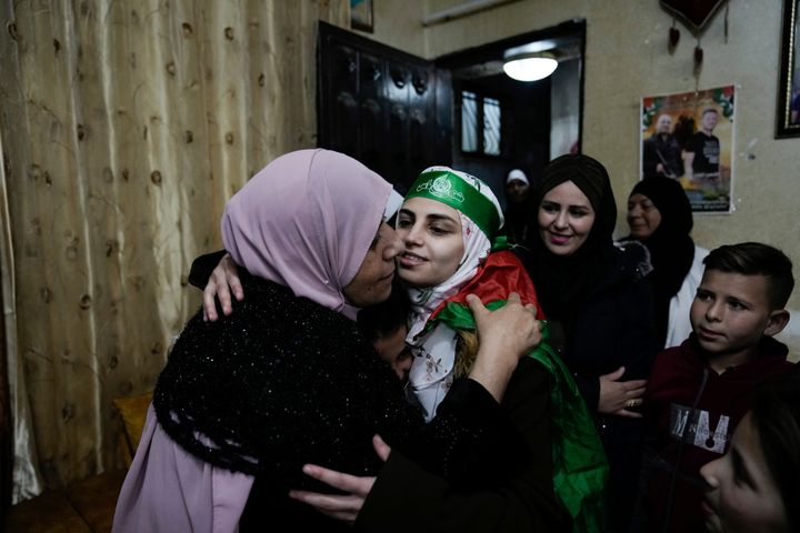 Aseel al-Titi, wearing a Hamas headband, a former Palestinian prisoner who was released by the Israeli authorities, is greeted by friends and family members in Balata, a Palestinian refugee camp in Nablus, West Bank, on Nov. 24, 2023. 