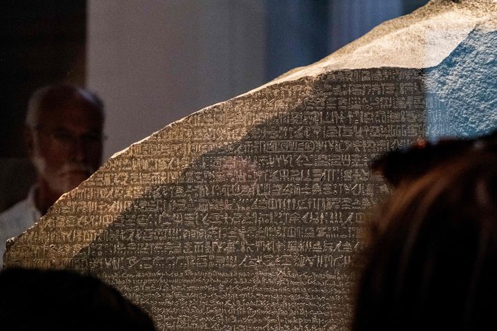 Visitors view the Rosetta Stone at the British Museum in London on July 26, 2022