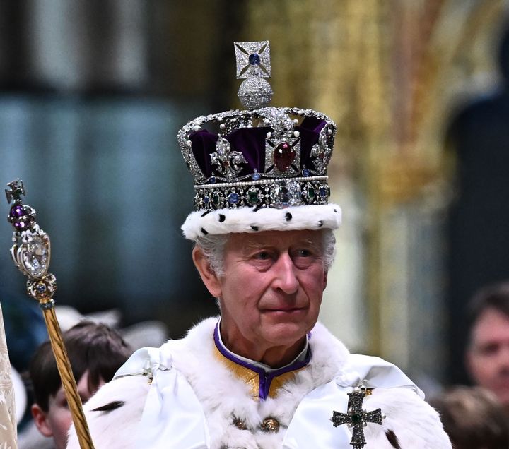 King Charles III wearing the Imperial state Crown carrying the Sovereign's Orb and Sceptre leaves Westminster Abbey after the Coronation Ceremonies in central London on May 6, 2023. 