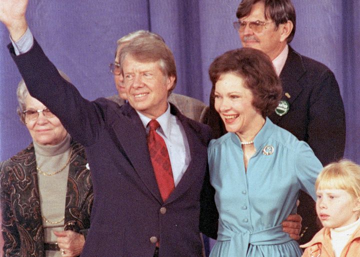 President-elect Jimmy Carter waves to supporters as he is surrounded by family members at a hotel in Atlanta on Nov. 3, 1976.