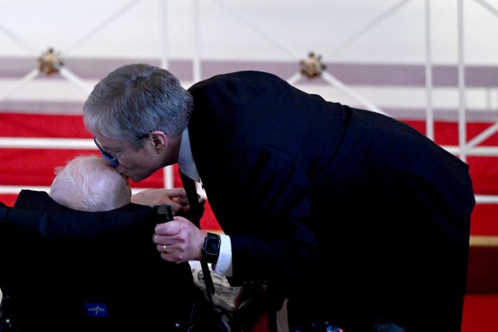 James Earl "Chip" Carter III kisses the head of his father, former President Jimmy Carter.