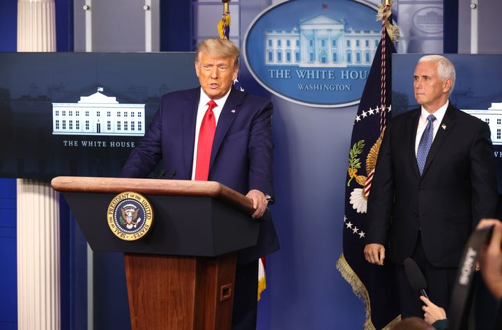 President Donald Trump speaks as Vice President Mike Pence stands behind him at the White House press briefing room on Nov. 24, 2020. A month later, Pence reportedly wrote that he should abdicate his role in overseeing the Electoral College count.