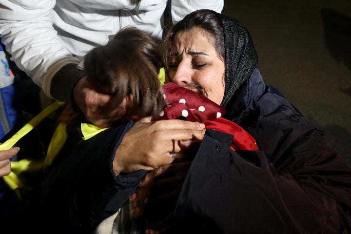 Newly released Palestinian prisoner Manal Dudeen hugs her daughter after disembarking a Red Cross bus transporting prisoners freed from Israeli jails in exchange for Israeli hostages released by Hamas from the Gaza Strip, during a welcome ceremony in Ramallah in the occupied West Bank on November 28, 2023. Israel's prison service said 30 Palestinian detainees were released on November 28, 2023 under the terms of a truce agreement between Israel and Hamas in the Gaza Strip. The announcement came after 10 Israeli hostages were freed in the Palestinian territory under the deal, along with two Thai citizens. (Photo by Jaafar ASHTIYEH / AFP) (Photo by JAAFAR ASHTIYEH/AFP via Getty Images)