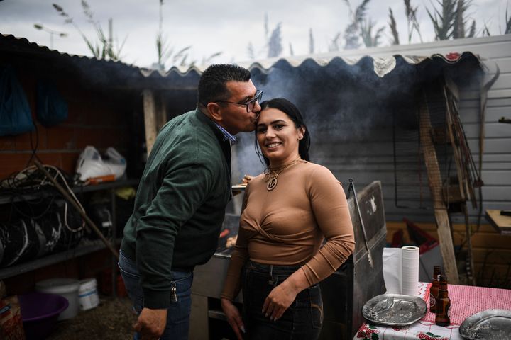 Jose Fernandes, president of the Techari association, which represents Roma people in his Lisbon District town of Camarate, kisses his daughter Vanessa at a family lunch on Jan. 15, 2022. Fernandes says Chega is inciting hatred and retaliation against Roma children in schools.