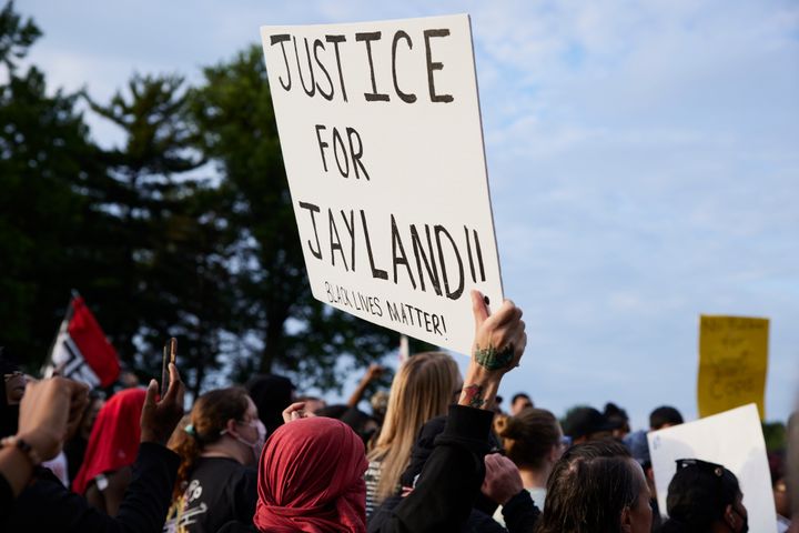 A demonstrator holds a sign during a vigil in honor of Jayland Walker on July 8, 2022, in Akron, Ohio. Walker had been killed by members of the Akron Police Department five days earlier.