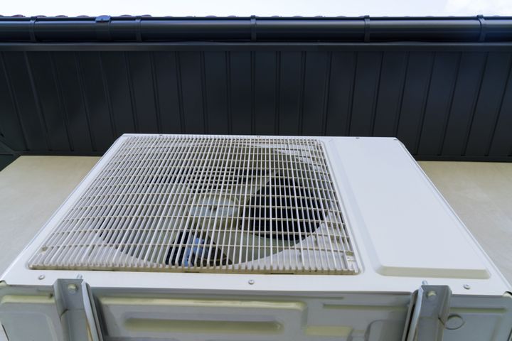 Heat pump on a grey wall at home