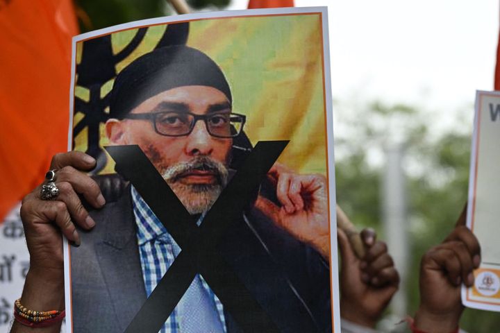 A member of United Hindu Front organisation holds a banner depicting Gurpatwant Singh Pannun, a lawyer believed to be based in Canada designated as a Khalistani terrorist by the Indian authorities during a rally along a street in New Delhi on September 24, 2023. (Photo by Arun SANKAR / AFP) (Photo by ARUN SANKAR/AFP via Getty Images)