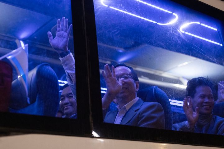 Thai nationals who were taken hostage by Hamas militants and recently released, wave from inside a bus as they leave the Shamir Medical Center near the city of Ramla, heading toward the airport to be flown home, on November 29, 2023. (Photo by Oren ZIV / AFP) (Photo by OREN ZIV/AFP via Getty Images)