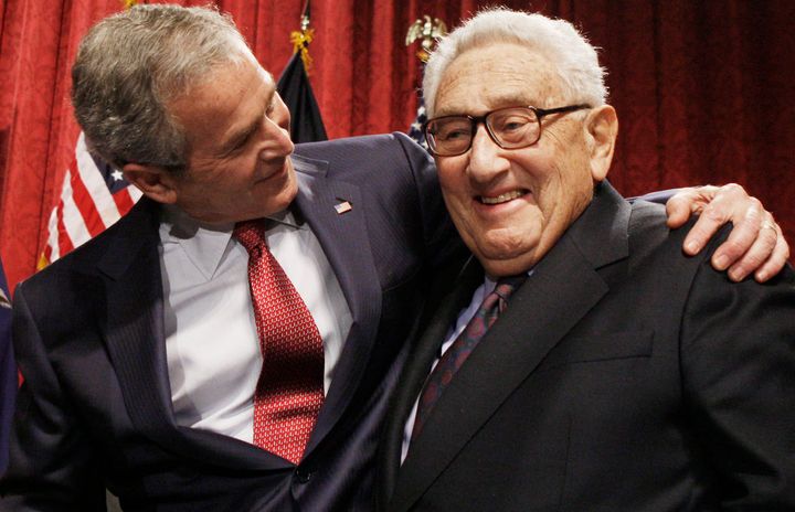 President George W. Bush stands with former Secretary of State Henry Kissinger in 2008. Kissinger, the diplomat with the thick glasses and gravelly voice who dominated foreign policy in the United States from 1969 to 1977, died Wednesday.