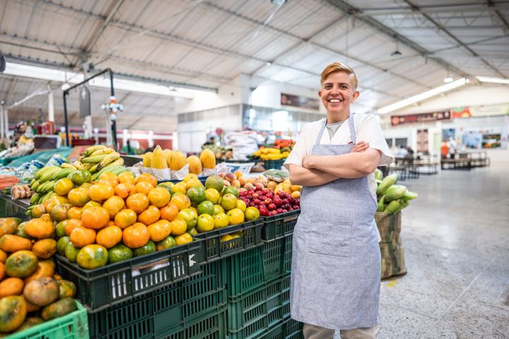 Portrait of a mature female retail clerk working at a greengrocer's shop