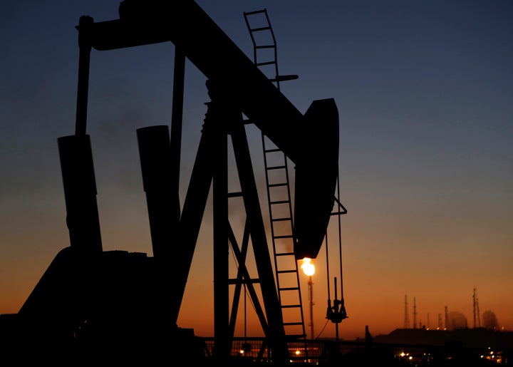 In this Jan. 18, 2016, file photo, an oil pump works at sunset, in the desert oil fields of Sakhir, Bahrain.