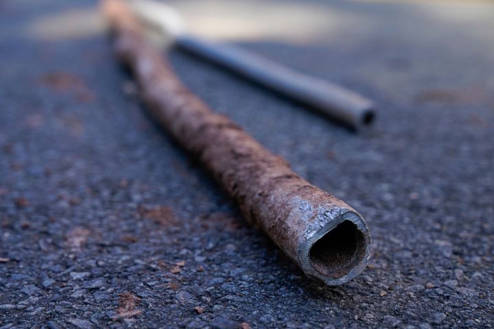 Lead water pipes pulled from underneath the street are seen in Newark, N.J., on Oct. 21, 2021. 