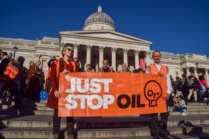 Activists march with a Just Stop Oil banner during a demonstration in Trafalgar Square. 