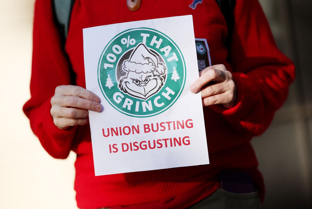 Members and supporters of Starbucks Workers United protest outside of a Starbucks store in Washington, D.C., on Nov. 16. The group held a series of rallies on Starbuck's holiday promotional Red Cup Day to demand Starbucks respect union rights.