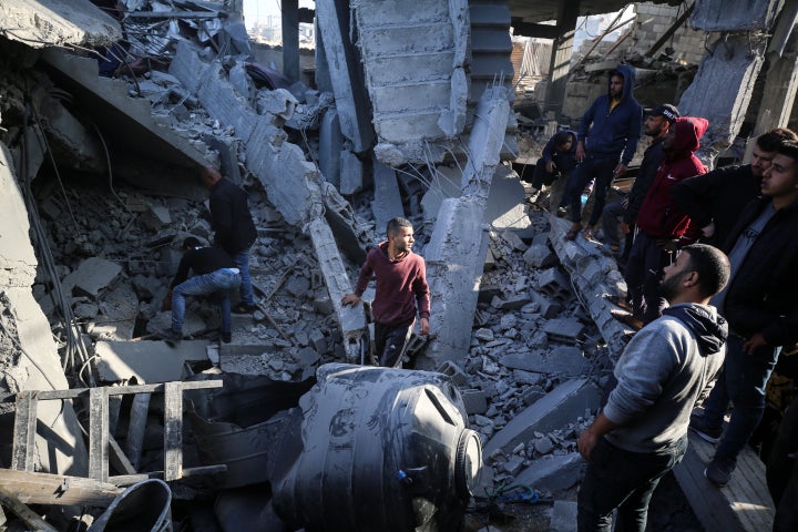 Palestinians are inspecting the damage in the rubble of a building destroyed during Israeli bombardment in Deir Balah in the central Gaza Strip, on December 2, 2023. (Photo by Majdi Fathi/NurPhoto via Getty Images)