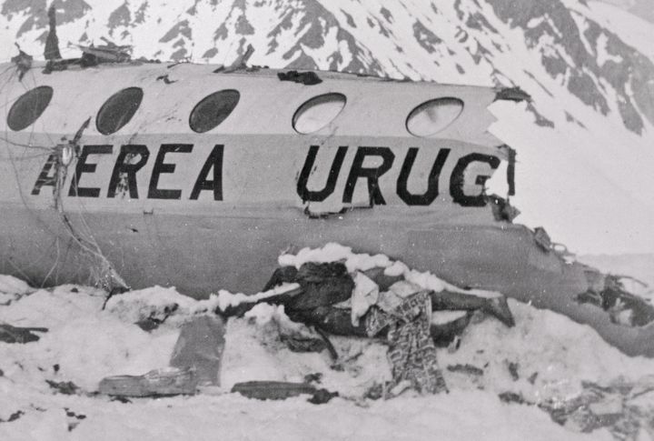 A body in the snow outside the wreckage of the crashed plane.