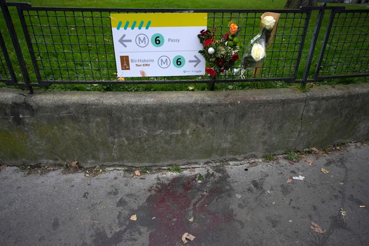 Flowers are placed on the scene where a man targeted passersbys late Saturday, Dec. 2, 2023, killing a German tourist with a knife and injuring two others in Paris