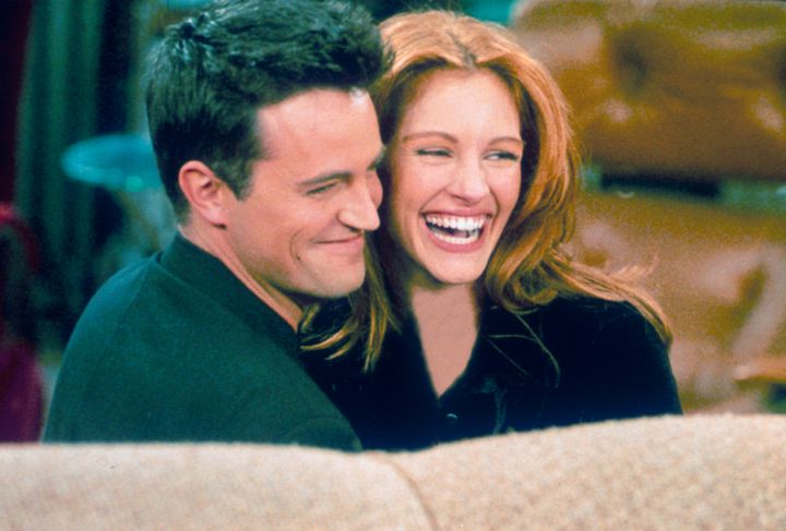 Actor Matthew Perry and actress Julia Roberts hug each other on the set of "Friends."