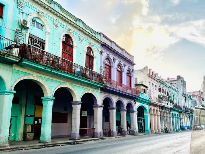 Havana, Cuba 11/2023: colorful architecture street scene -an array of buildings that boast a kaleidoscope of hues, showcasing a unique blend of Spanish colonial, Baroque, neoclassical, and art deco styles.