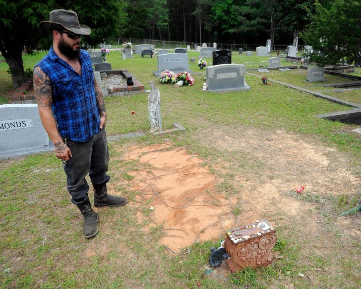 Tyler Goodson of the hit podcast "S-Town" stands at the grave in Green Pond, Ala., of his late friend John B. McLemore, who is also featured in the show, on May 3, 2017. Goodson, a man featured in the podcast which chronicled events in a rural Alabama community, died after being shot by police during a Sunday standoff, Dec. 3, 2023, a state agency said. 