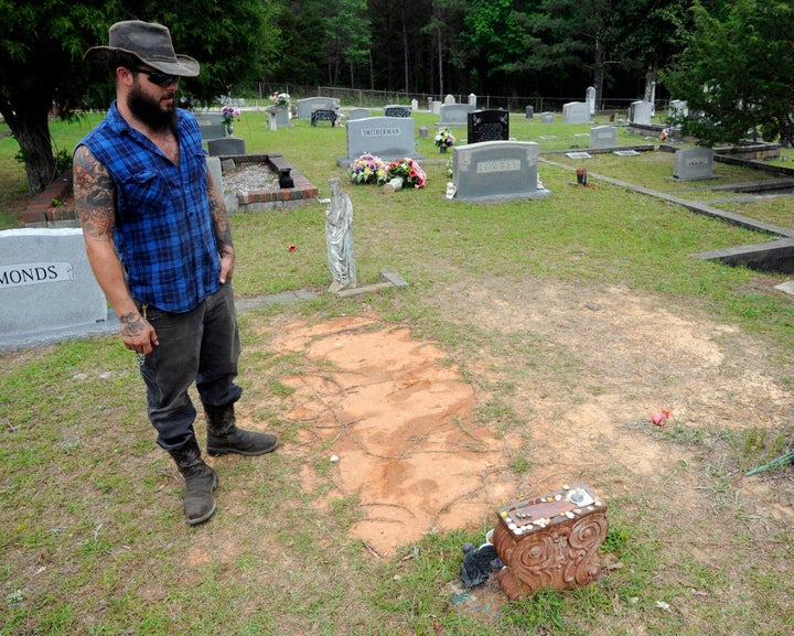 Tyler Goodson of the hit podcast "S-Town" stands at the grave in Green Pond, Ala., of his late friend John B. McLemore, who is also featured in the show, on May 3, 2017. Goodson, a man featured in the podcast which chronicled events in a rural Alabama community, died after being shot by police during a Sunday standoff, Dec. 3, 2023, a state agency said.