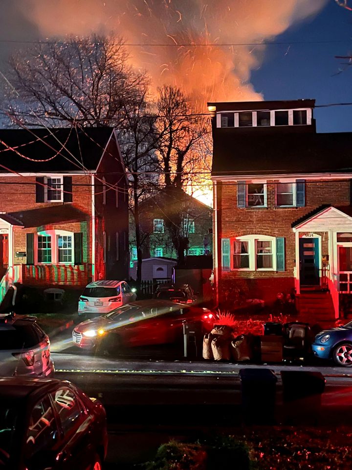 A home is seen exploding from a distance on Dec. 4, 2023, in Arlington, Va. Arlington County Police in a Virginia suburb of the nation’s capital are investigating an explosion at a residence where officers were trying to serve a search warrant Monday.