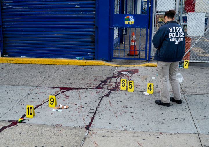 In a Sept. 5, 2016, file photo, crime scene investigators with the New York Police Department work at the scene where multiple people were killed and others injured in a shooting during J'ouvert festivities in Brooklyn, New York.