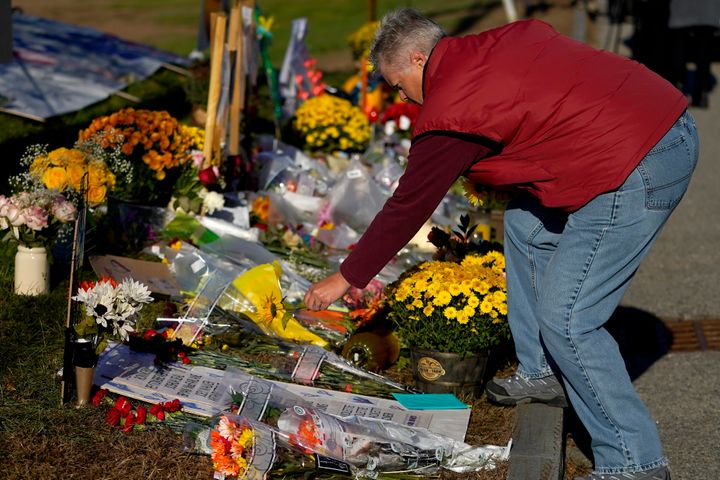 A community member places flowers at a memorial in Lewiston, Maine, on Nov. 3. Eighteen people were killed there in a mass shooting, the deadliest in the state's history.