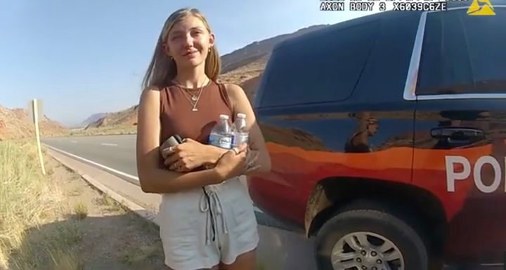 Gabrielle "Gabby" Petito is seen talking to a police officer after the van she was traveling in with Brian Laundrie was pulled over in Utah on Aug. 12, 2021. The 22-year-old was found dead the following month.
